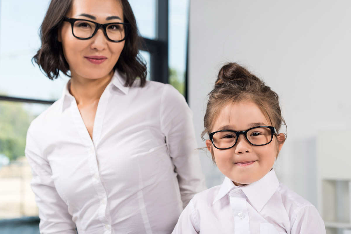 Asian mother and son with their eyeglasses from vision insurance