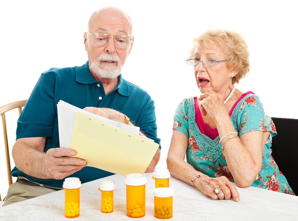 Old couple reading their Medicare Health Insurance (DHHS)