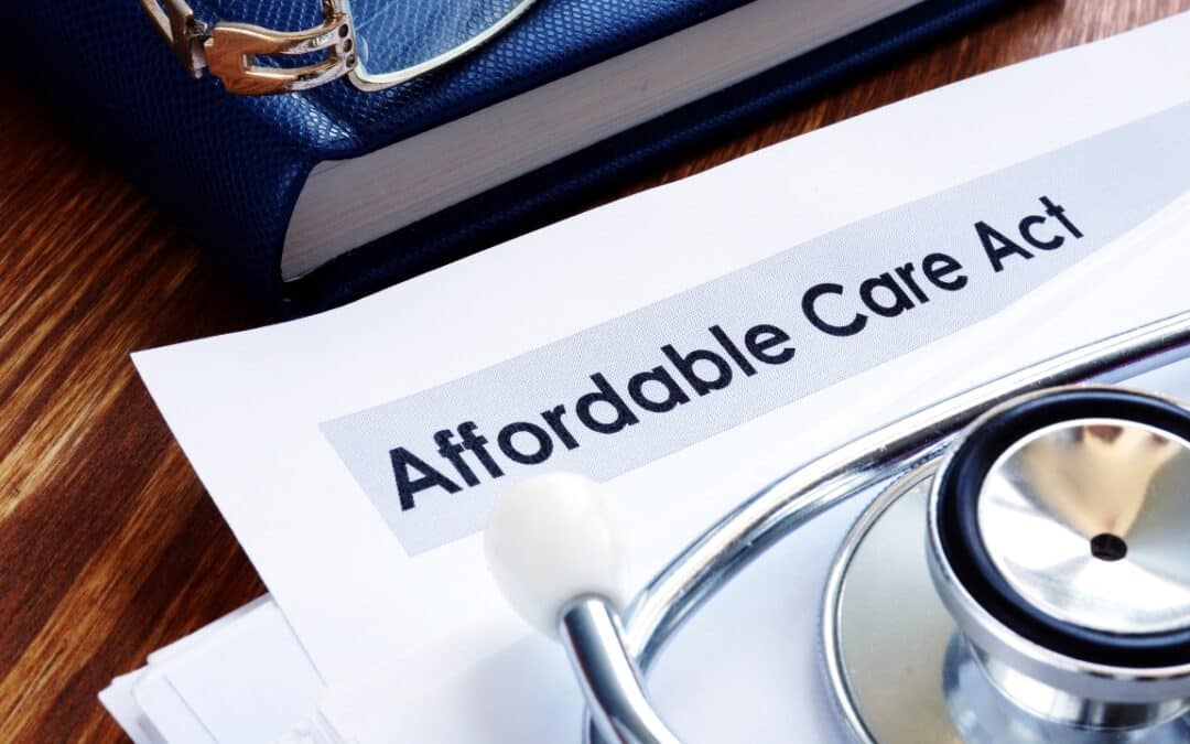 a piece of paper that says "affordable care act" and a stethescope