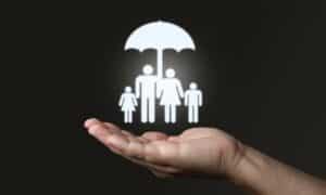 a small LED family under an umbrella on a peerson's hand