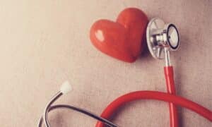 a stethoscope on a wooden heart
