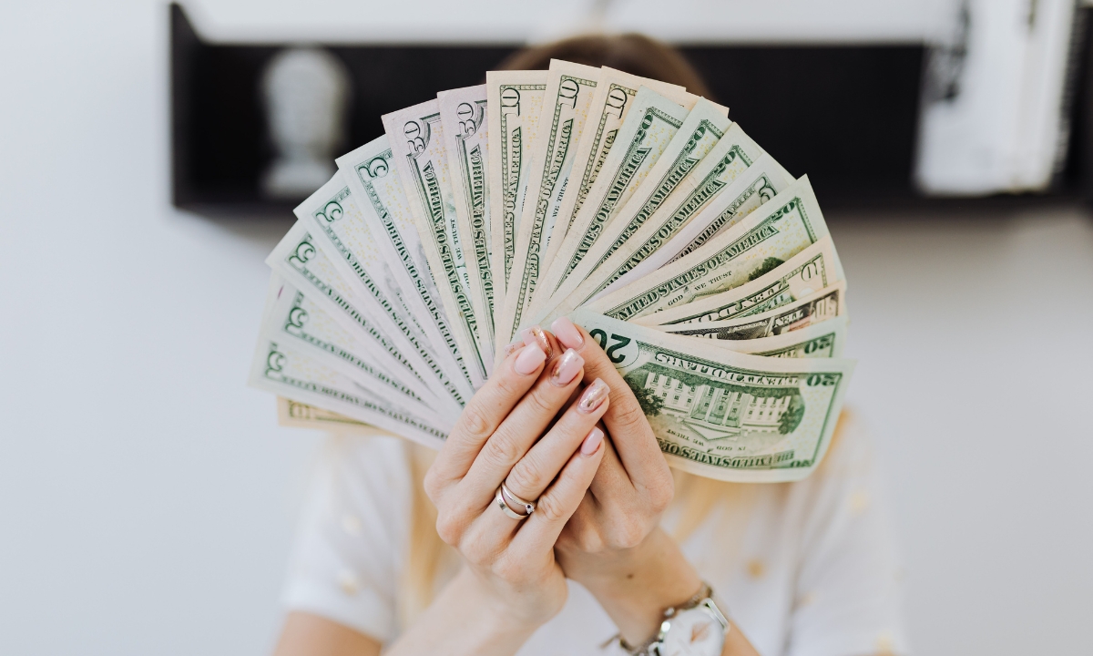 a person holding fanned out cash