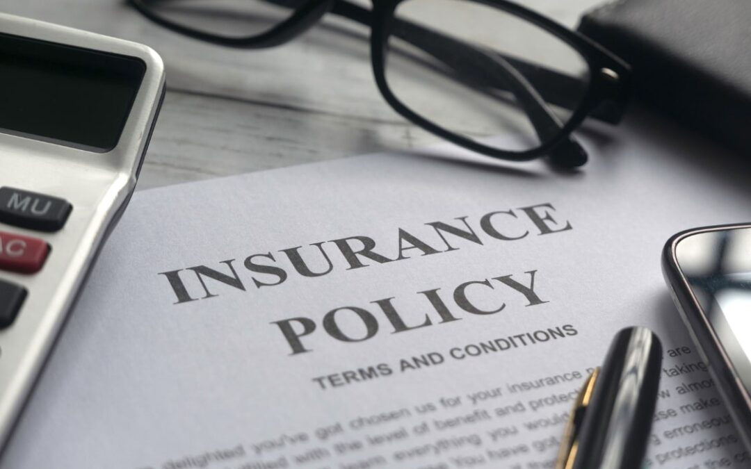 An insurance policy document on a desk being ready to be reviewed